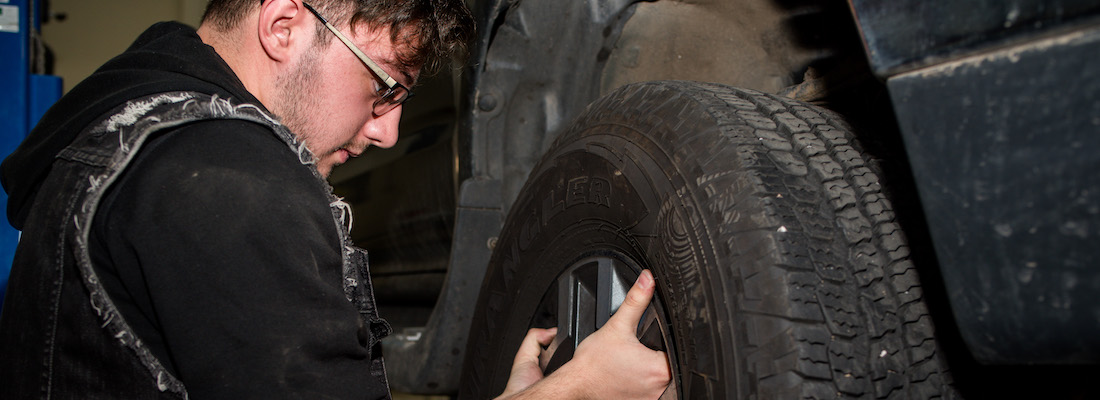 Student with a vehicle tire