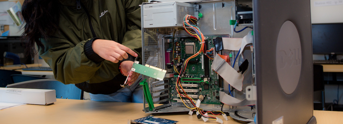 Student's hands building computer